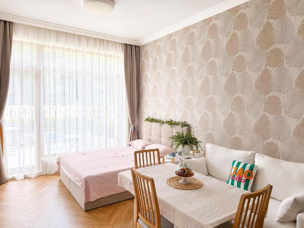 a dining room with a table and chairs at Coral Bay Studio Varna - Beachfront with Free Parking in Varna City
