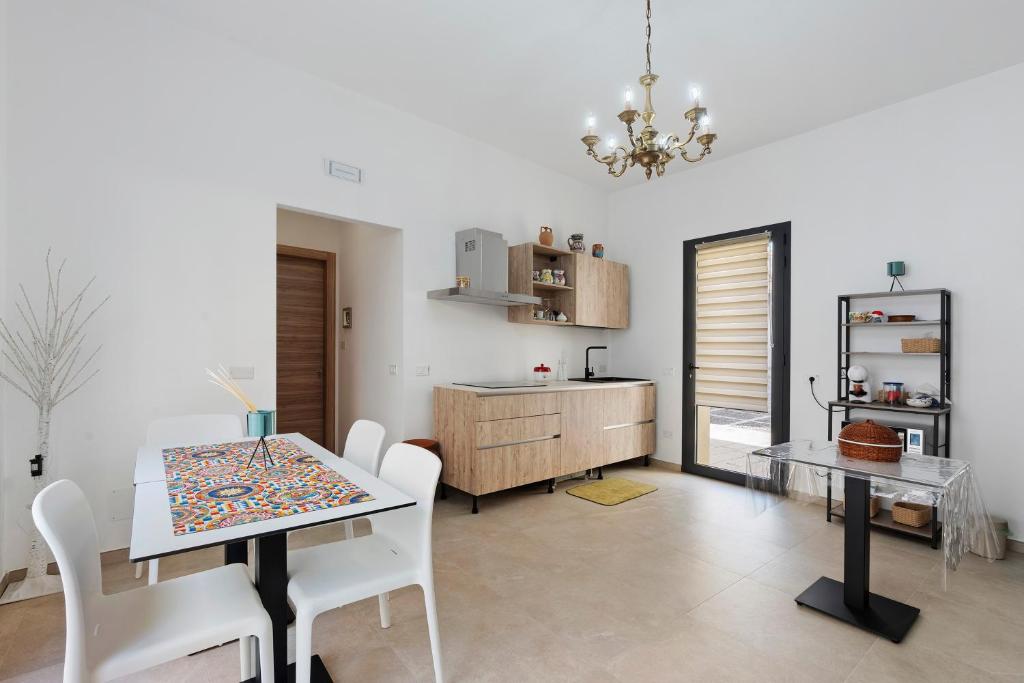 a kitchen and dining room with a table and chairs at ByAma Holiday House in Menfi