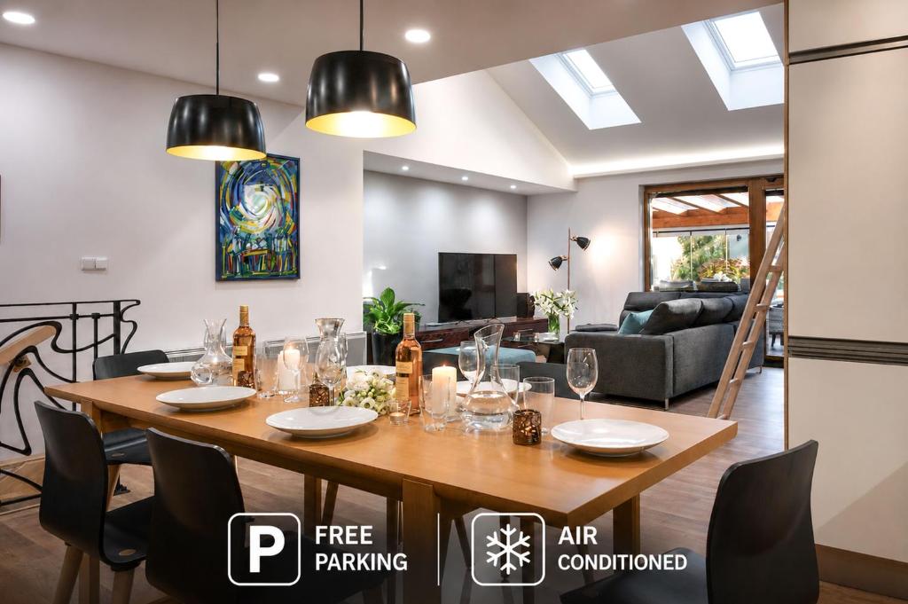 a dining room and living room with a table and chairs at Rezidence Adalbert in Valtice