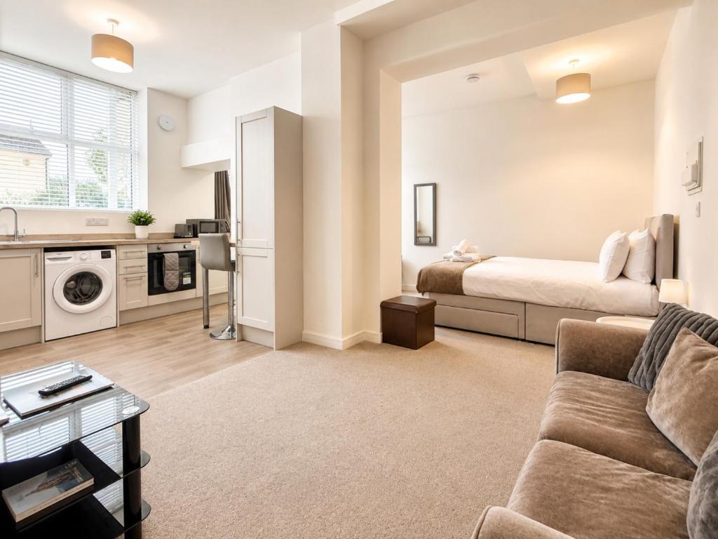 a living room with a couch and a bed at Modern new redeveloped studio Apartment in Clacton in Clacton-on-Sea