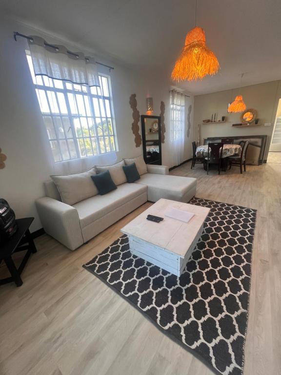 a living room with a couch and a table at Appartement Lili in Grand-Baie