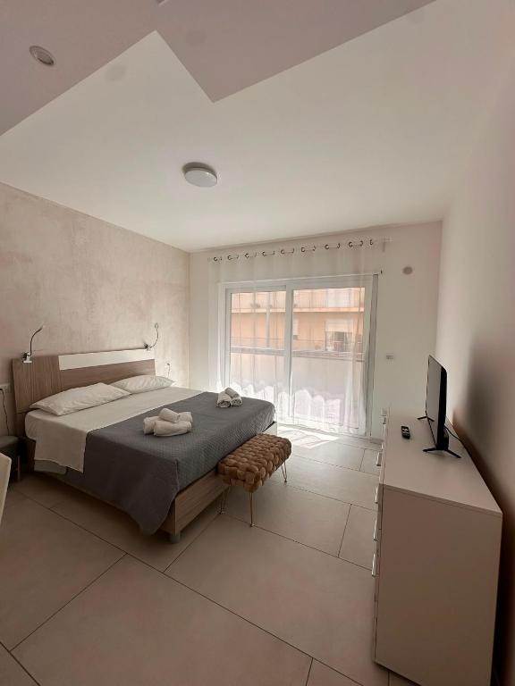 a bedroom with a bed and a television in it at D&F Guest House in Milazzo