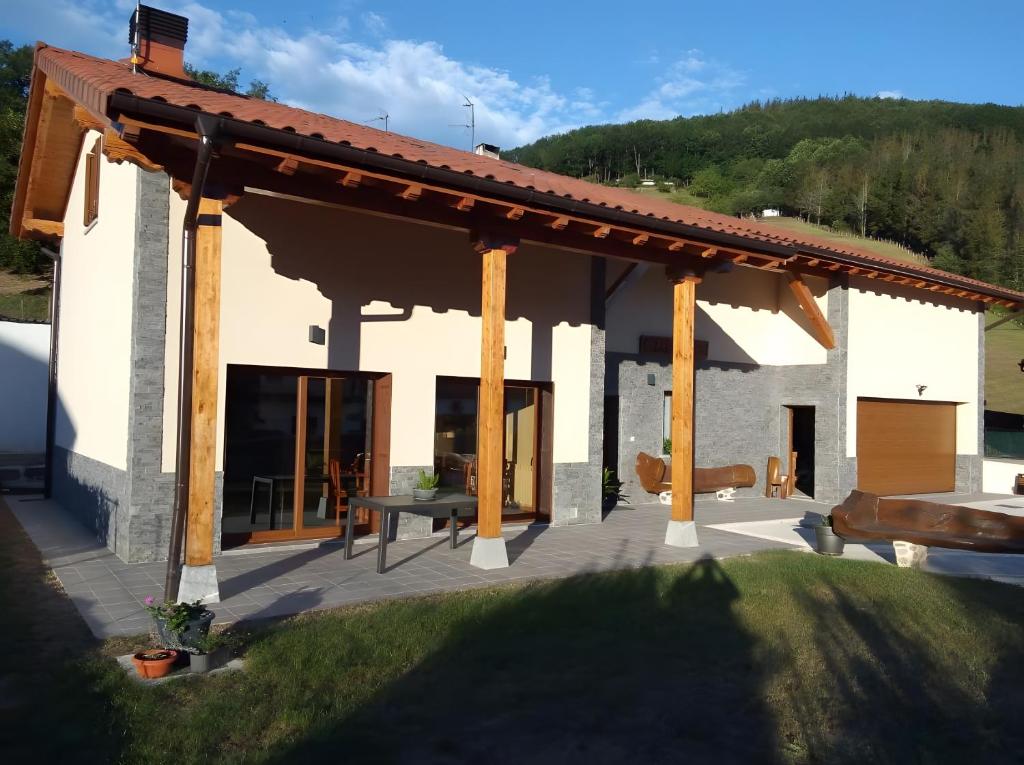 a pavilion with a picnic table on a patio at Argixti in Sumbilla
