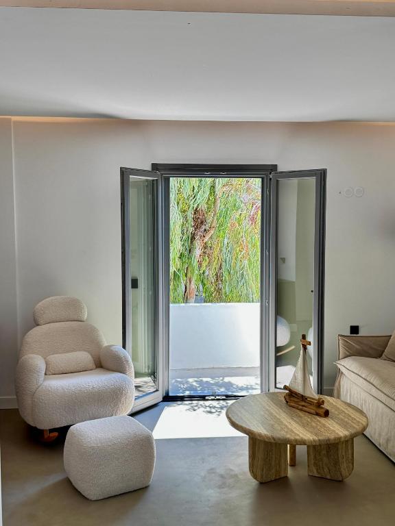 a living room with a chair and a coffee table at Almond Chambers in Naousa