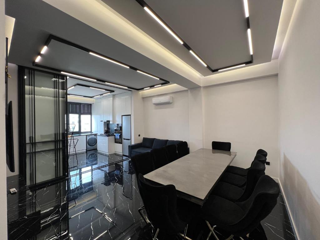 a meeting room with a table and chairs at Hi-Tech Apartment in Tashkent