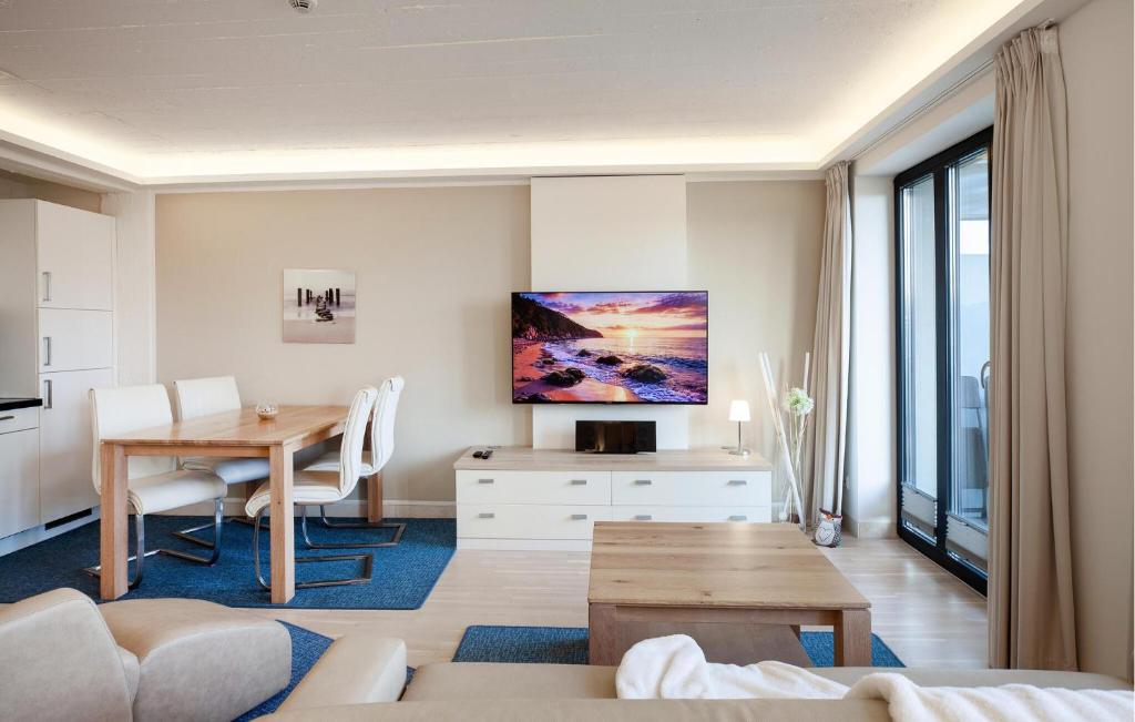 a living room with a table and a television at Princess in Binz