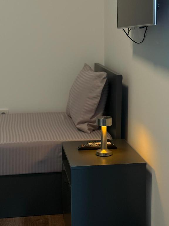 a bedroom with a bed and a table with a candle at Ajazi Rooms in Struga