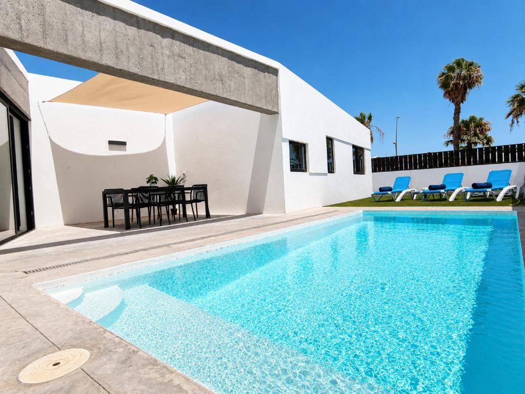 a swimming pool in front of a villa at Villa Drago in Antigua