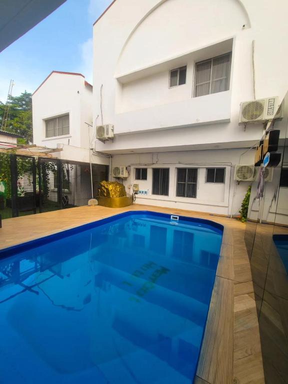 a swimming pool in front of a house at Mareot Hotel and Lounge in Maiyegun