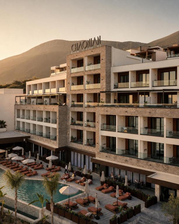 an image of a hotel with a swimming pool at Chaonian Hotel in Dhërmi