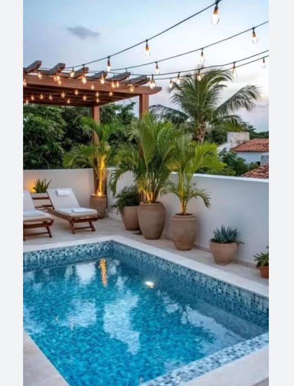 a swimming pool on a patio with a pergola at The nook in Rāmnagar