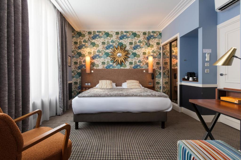 ein Schlafzimmer mit einem Bett und einem Schreibtisch in einem Zimmer in der Unterkunft Hotel Maison Lia in Châlons-en-Champagne