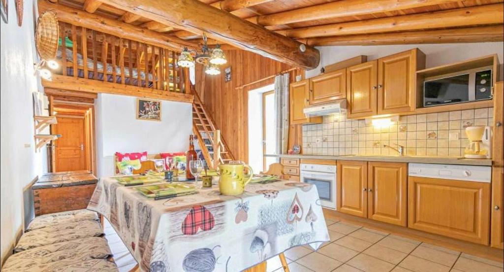 a kitchen with a table in the middle of it at Chalet le Vernès Marmotte in Bonneval-sur-Arc