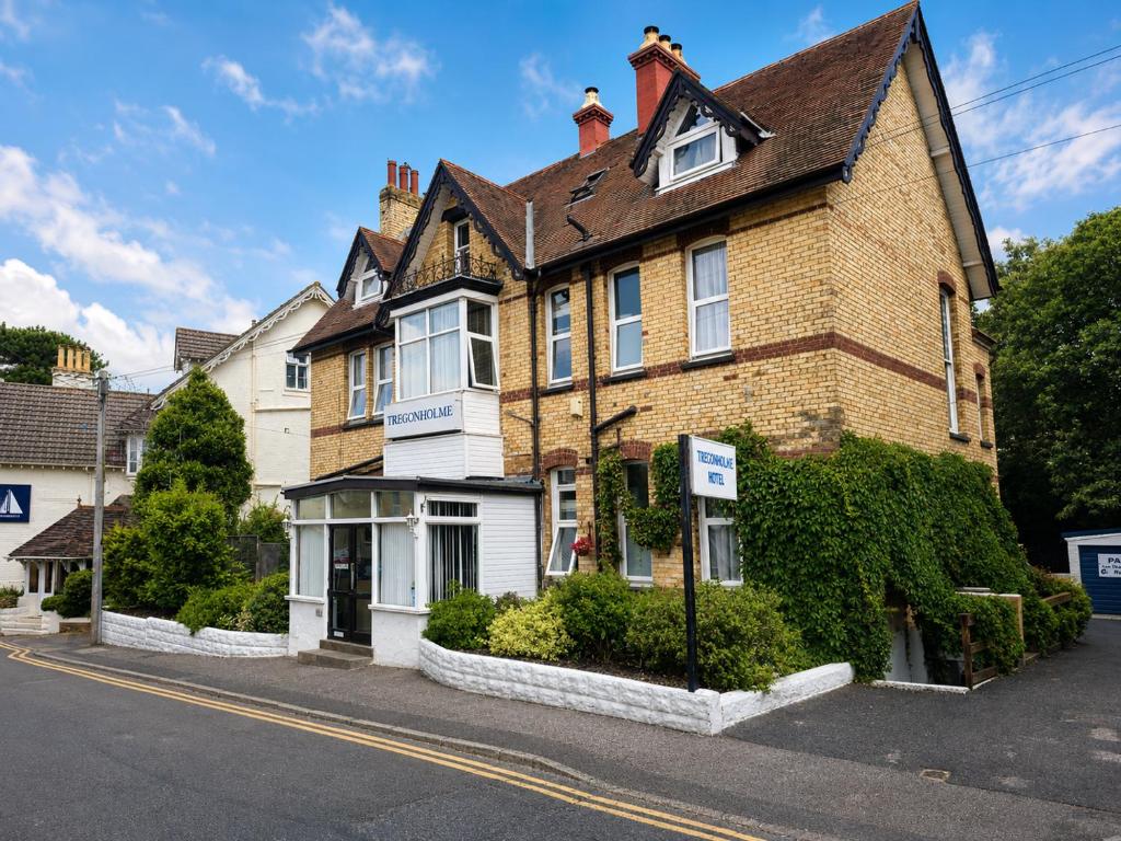 a large brick house on the side of a street at Tregonholme Hotel in Bournemouth