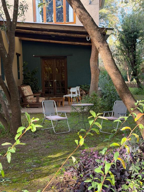 a patio with chairs and a table in front of a house at Varuna- en La Casa de Nanda in San Javier