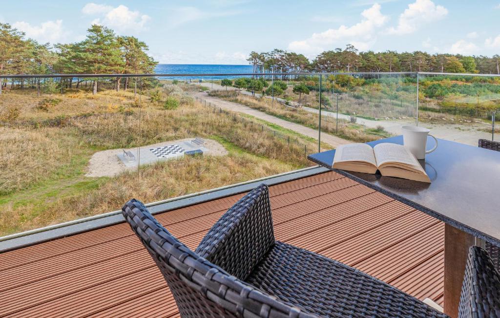 a balcony with a table and chairs and a view of the ocean at Eden in Binz