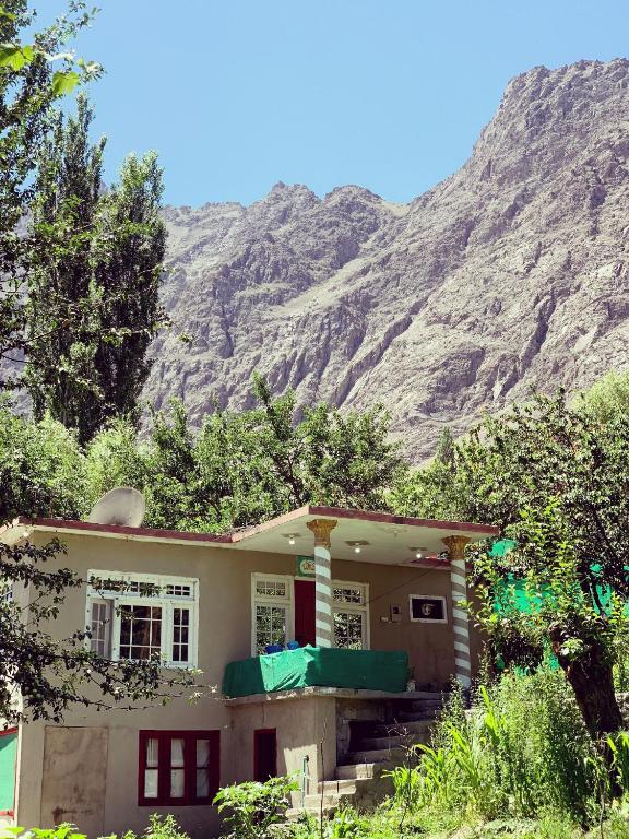 a house with a mountain in the background at Stone Leaf Retreat - Skardu in Skardu