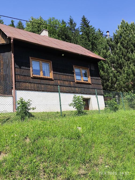 a house with a fence in front of it at Chalupa Meduňka in Vsetín