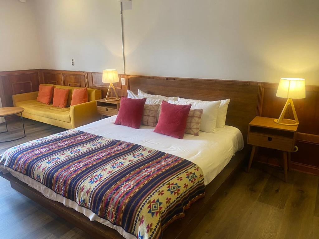 a bedroom with a large bed and two lamps at Cavi Rooms 511 in Cuenca