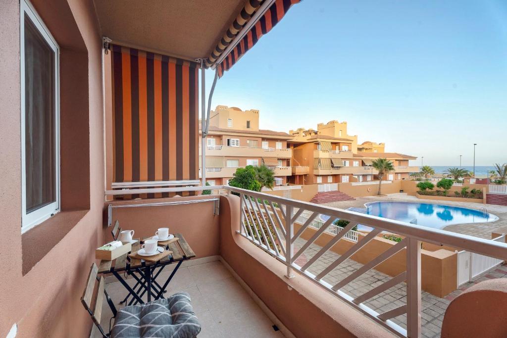 a balcony with a view of a pool and buildings at Residencial La Gomera in Puertito de Güímar