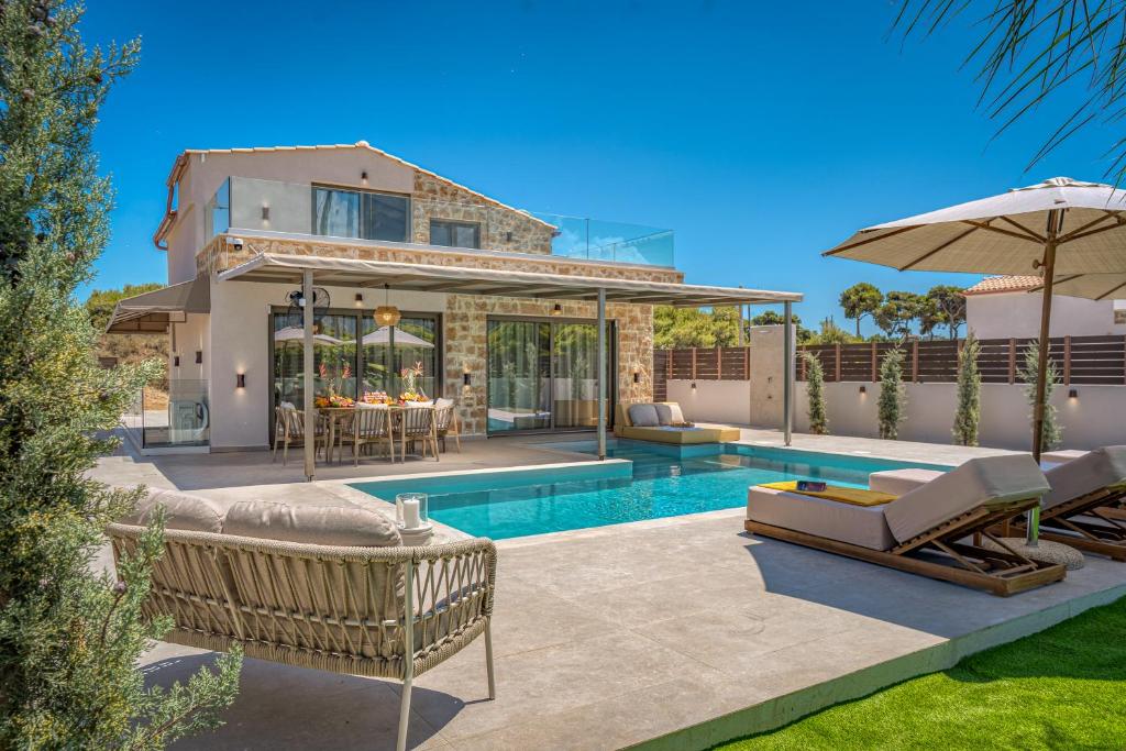 a villa with a swimming pool and a house at Alpha Waves By Banana Beach in Vasilikos