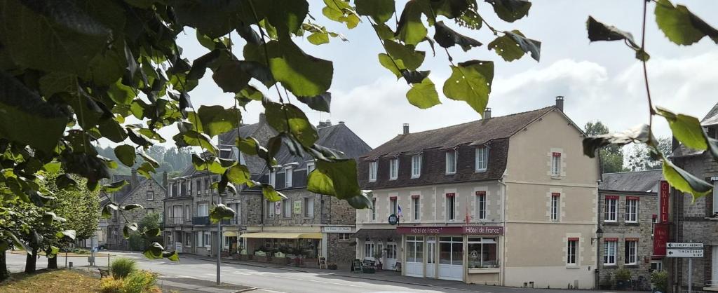 a row of buildings on a city street at Logis Hôtel De France- Restaurant GRILL in Domfront