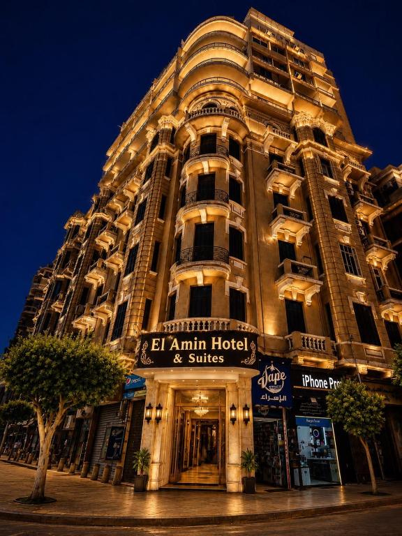 a tall building with a sign in front of it at El Amin Hotel & Suites - Downtown Cairo in Cairo