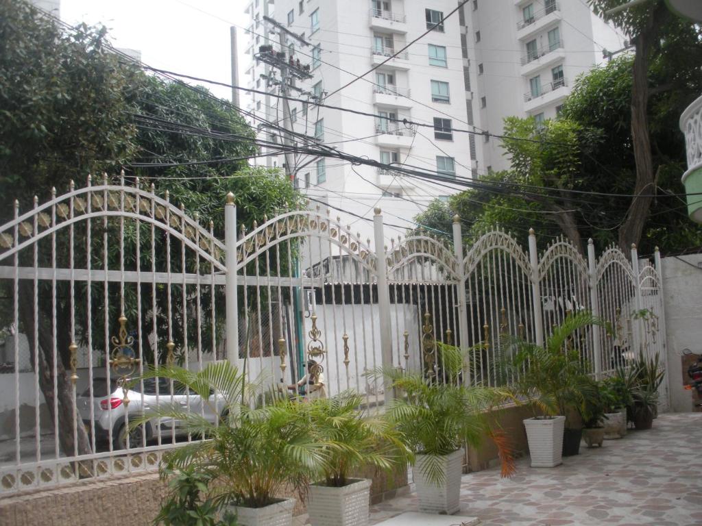 a white gate with plants in front of a building at Reina Elizabeth I in Santa Marta