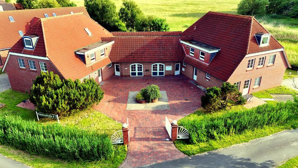 an aerial view of a house with a red roof at elf-36 Apartmenthaus Bensersiel in Bensersiel