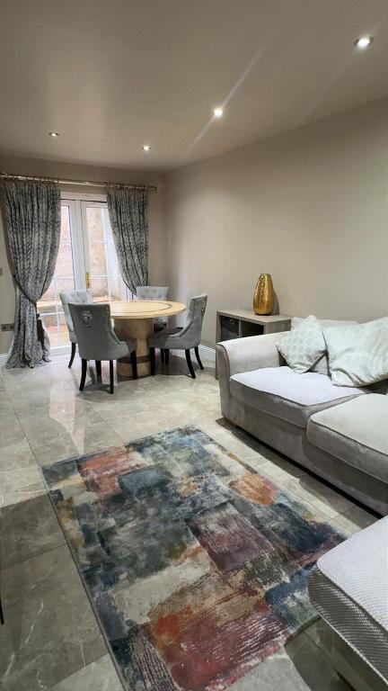 a living room with a couch and a table at 18 Garden Mews in Cookstown