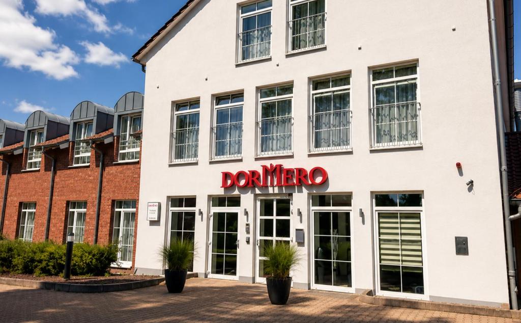 a building with a donner sign on it at DORMERO Hotel Werther in Werther