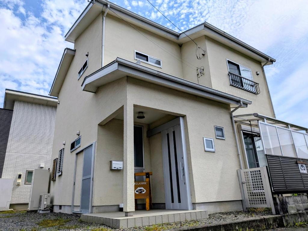 a large white house with the front of it at Frog Inn - Entire House for Private Use in Fujinomiya