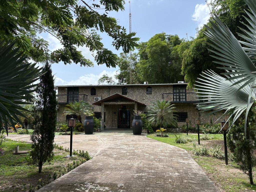 a building with palm trees in front of it at Villa Toscana in Maturín