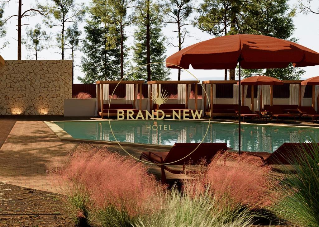 a hotel with an umbrella and chairs and a pool at Aura by Aubamar in Playa de Palma