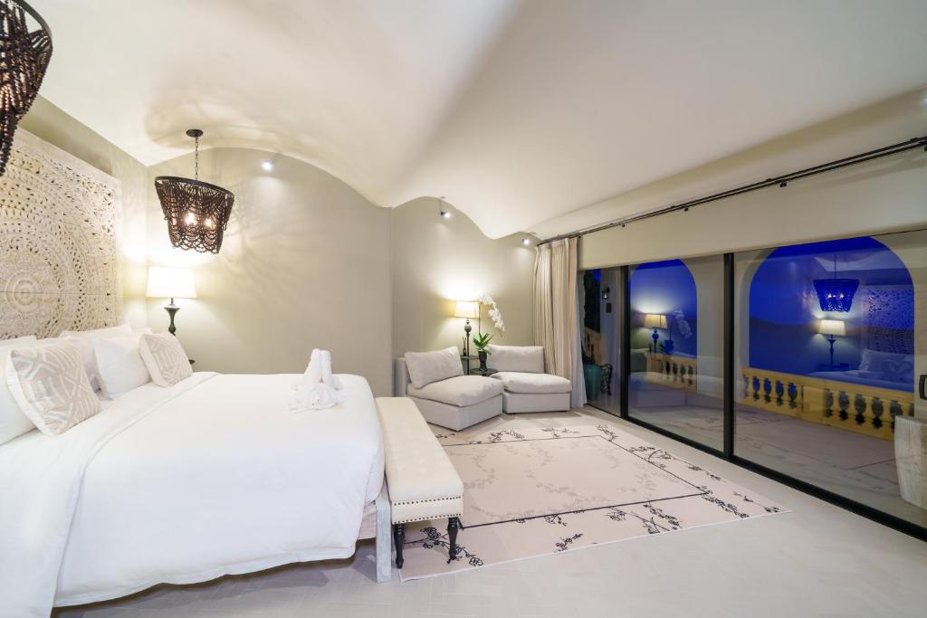a bedroom with a white bed and a balcony at Ladylagoon Luxury Multi-Purpose Private Beachfront Villas Koh Samui in Koh Samui