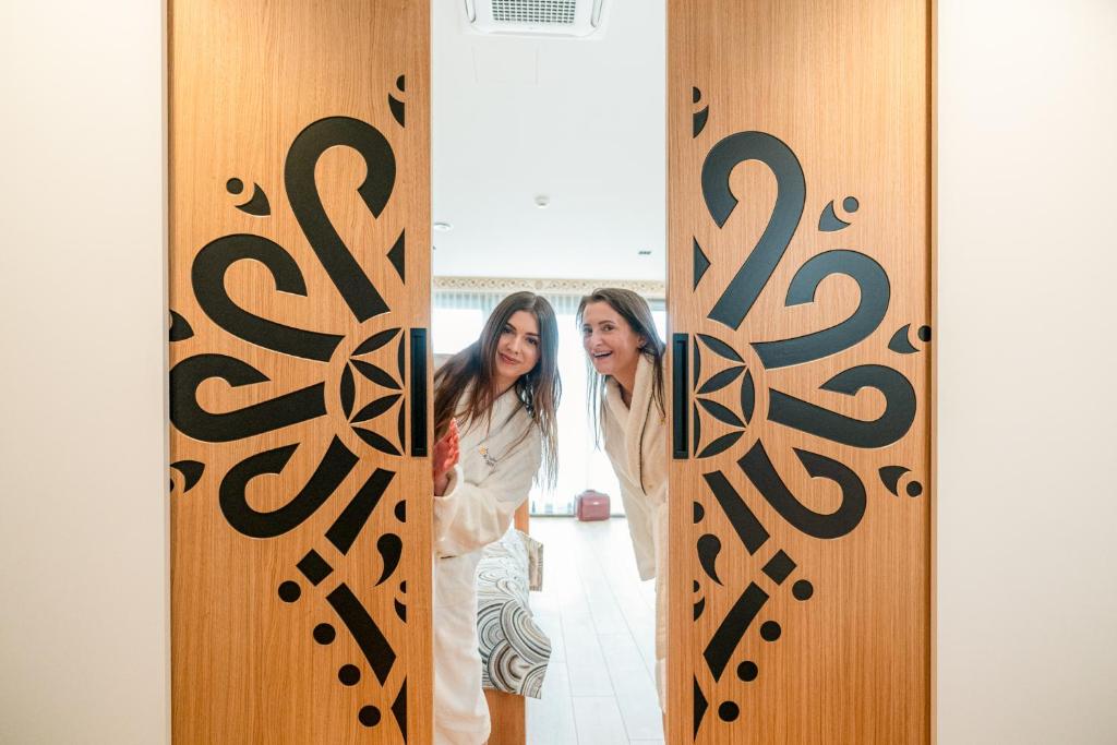 two women standing in front of a door at Termalne Spanie w Chochołowskich Termach in Chochołów