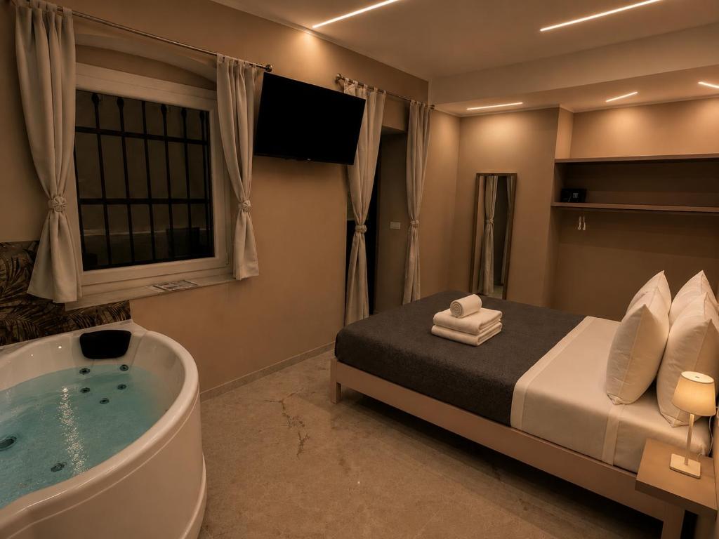a bedroom with a bed and a bath tub at Romantic Suite Genova in Genoa