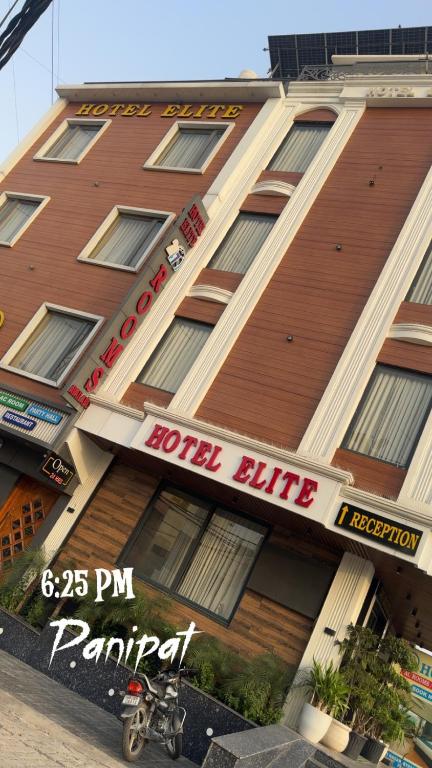 a motorcycle parked in front of a hotel building at HOTEL ELiTE in Pānīpat