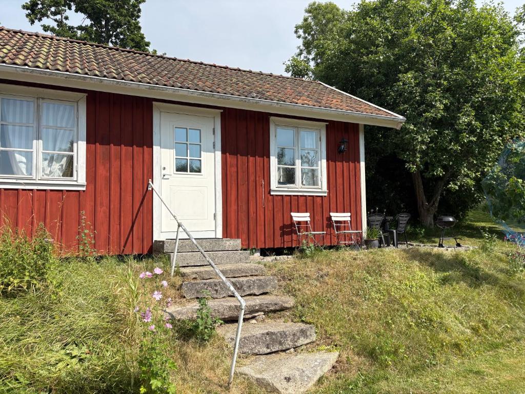 a red and white house with stairs leading to it at Övertun in Hamburgsund