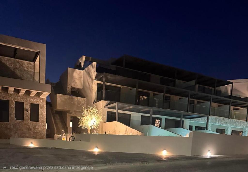 a large building at night with lights on it at Kefalos View in Vrachonisída Palaiókastro