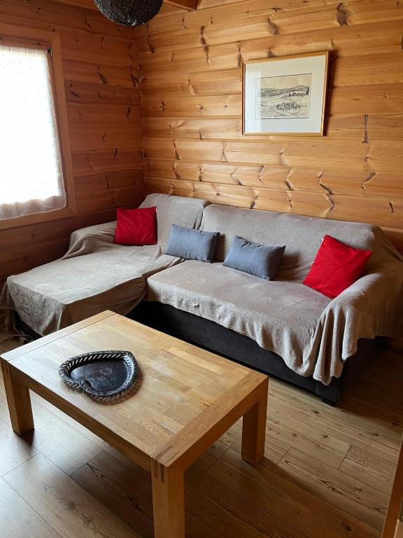 a living room with a couch and a table at Chalet airelles in Saint-Pierre