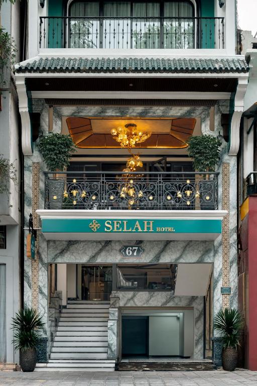 a building with stairs and a sign on it at Selah Hanoi Hotel in Hanoi