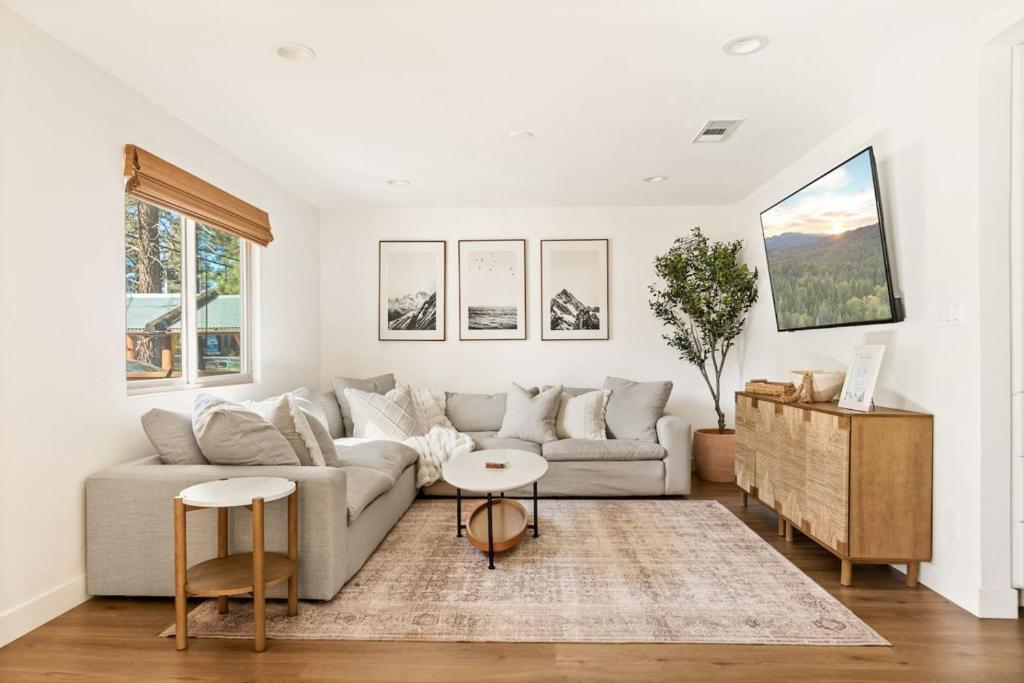 a living room with a couch and a table at Modern Hideaway in Big Bear in Big Bear City