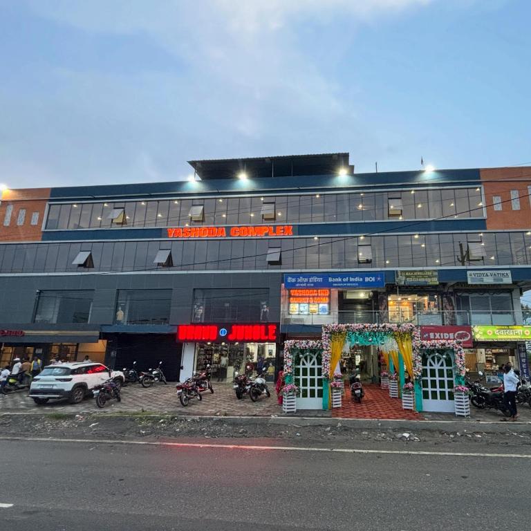 a building with motorcycles parked in front of it at Yashoda Inn in Ormānjhi