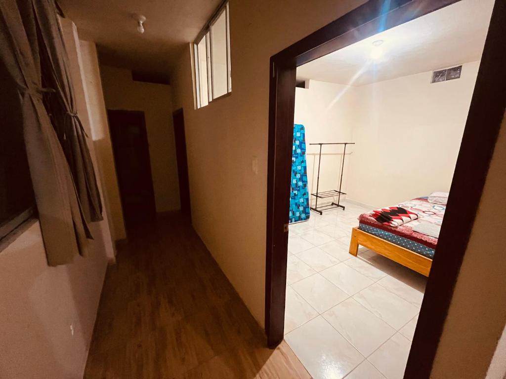 a room with a door leading to a bedroom with a bed at Estancia 3 in Tena