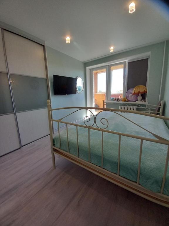 a bedroom with a bed with a mirror and a tv at Amber Beach Apartment in Narva-Jõesuu