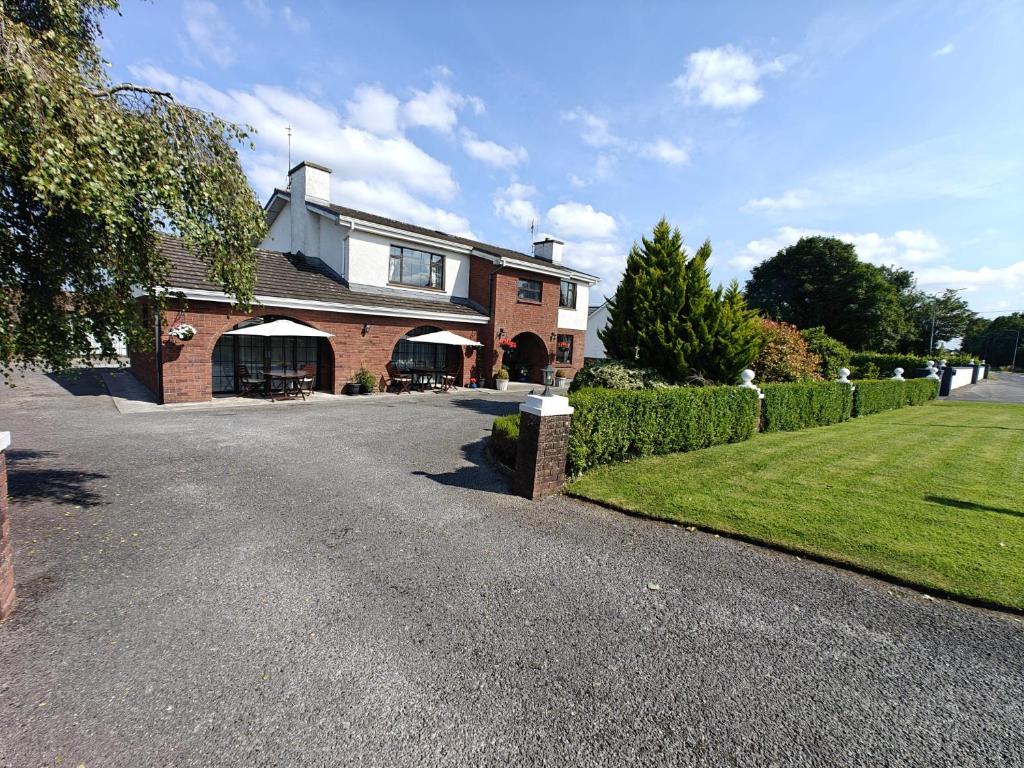 a brick house with a driveway in front of it at Riverview House in Athlone