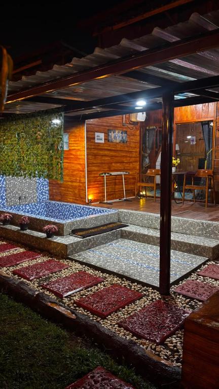 a room with a patio with tiles on the ground at The Ci Dwi resort in Cicadas