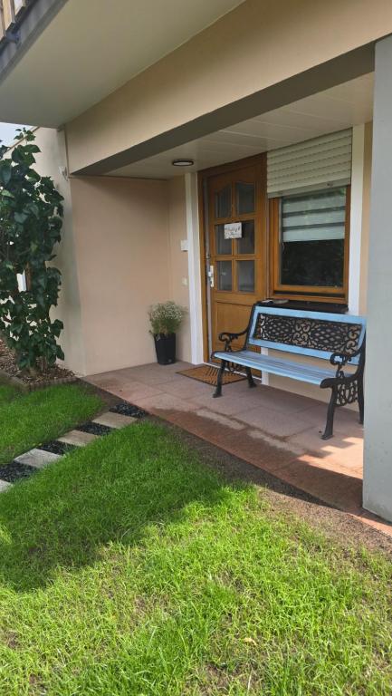 a bench sitting on the porch of a house at Pfälzerblick Lambrecht- Ferienwohnung mit Garten in Lambrecht