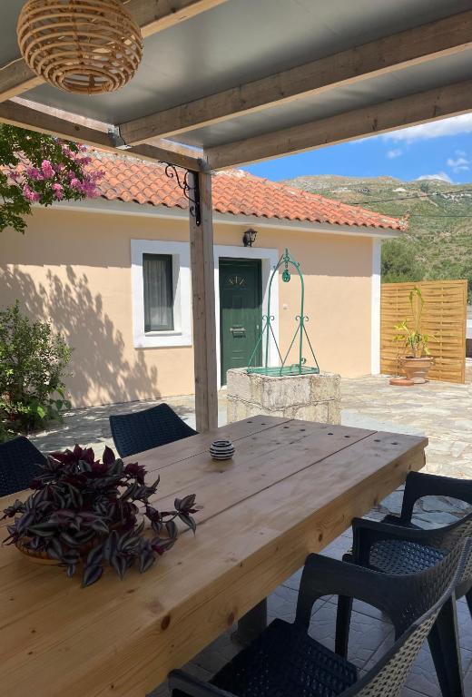 a wooden table and chairs on a patio at Anabelis studios & apartments in Katelios